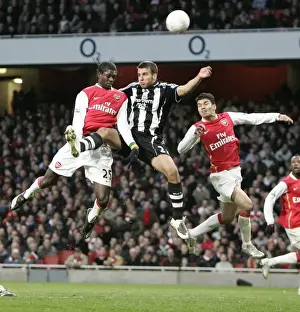 Emmanuel Adebayor and Eduardo (Arsenal) jump with Steven Taylor (Newcastle)