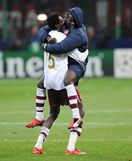 Emmanuel Adebayor and Emmanuel Eboue celebrate Arsenals victory