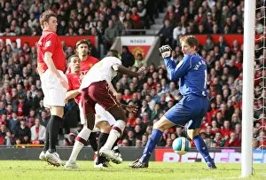 Emmanuel Adebayor heads past Manchester United goalkeeper Edwin van der Sar to score the Arsenal goal