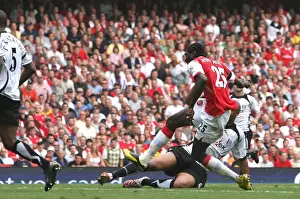 Emmanuel Adebayor shoots past Fulham goalkeeper Antti Niemi to score the 2nd Arsenal goal