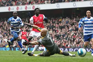 Emmanuel Adebayor shoots past Reading goalkeeper Marcus Hahnemann to score the 1st Arsenal goal