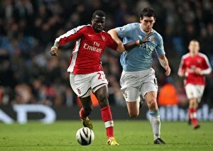 Manchester City v Arsenal - Carling Cup 2009-10 Collection: Emmanuel Eboue (Arsenal) Gareth Barry (Man City). Manchester City 3: 0 Arsenal