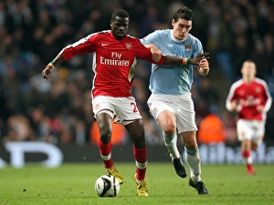 Manchester City v Arsenal - Carling Cup 2009-10 Collection: Emmanuel Eboue (Arsenal) Gareth Barry (Man City). Manchester City 3: 0 Arsenal