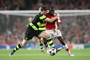 Arsenal v Celtic 2009-10 Collection: Emmanuel Eboue (Arsenal) Gary Caldwell (Celtic)