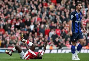 Emmanuel Eboue (Arsenal) holds his ankle following a challenge from Lorik Cana