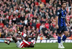 Arsenal V Sunderland 2009-10 Prints: Emmanuel Eboue (Arsenal) holds his ankle following a challenge from Lorik Cana