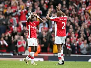 Images Dated 14th March 2009: Emmanuel Eboue celebrates at the end of the match with Abou Diaby