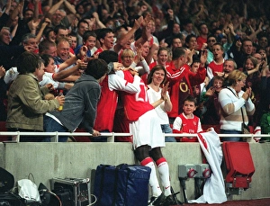 Emmanuel Eboue celebrates with the fans after Thierry Henrys goal for Arsenal Emmanuel Eboue celebrates with the fans after Thierry Henrys goal for Arsenal