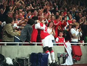 Arsenal V FC Porto Prints: Emmanuel Eboue celebrates with the fans after Thierry Henrys goal for Arsenal