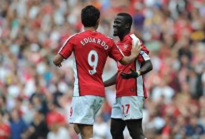 Eduardo Collection: Emmanuel Eboue celebrates scoring the 3rd Arsenal goal with Eduardo