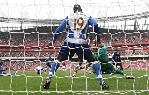 Emmanuel Eboue deflects the ball past Wigan goalkeeper Emmanuel Eboue deflects the ball past Wigan goalkeeper