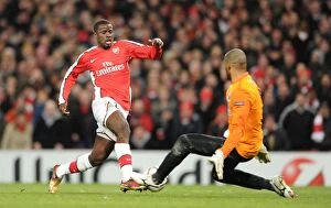 Images Dated 9th March 2010: Emmanuel Eboue goes past Porto goalkeeper Helton to score the 4th Arsenal goal