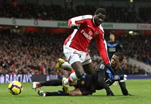 Arsenal v Manchester United 2009-10 Collection: Emmanuel Eboue vs. Patrice Evra: Arsenal vs. Manchester United's Intense Rivalry (31/01/10)