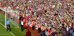 Images Dated 7th April 2005: The fans in the Clock End wave at Arsene Wenger. Arsenal 2: 1 Leicester City