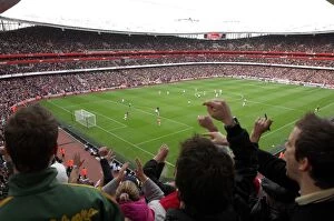 Fans Collection: Fans jump up in the upper terrace to celebrate Emmanuel Adebayor scoring Arsenals 1st goal