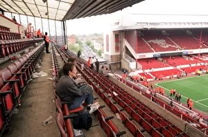 Fans sit in the North Bank as Arsenal Stadium empties after the match and Final Salute Events