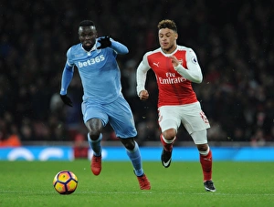 Arsenal V Stoke City 2016-17 Prints: Fierce Rivalry: Oxlade-Chamberlain vs. Diouf Clash at Arsenal v Stoke City (2016-17)