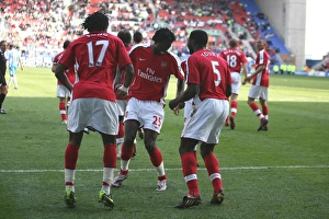 Fourth Goal Celebration: Alex Song, Emmanuel Adebayor, and Kolo Toure, Arsenal's Winning Moment against Wigan Athletic in the Premier League