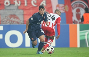 Images Dated 9th December 2009: Fran Merida (Arsenal) Leonardo (Olympiacos). Olympiacos 1: 0 Arsenal, UEFA Champions League