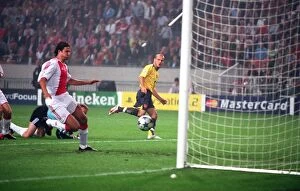 Ajax v Arsenal - Champions League 2005-6 Collection: Freddie Ljungberg chips the ball over Ajax goalkeeper Hans Vonk to score the 1st Arsenal goal