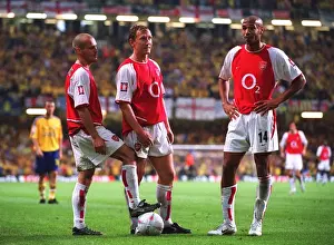 Freddie Ljungberg, ray Parlour and Thierry Henry (Arsenal) stand over the ball before taking a free