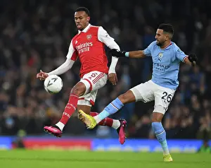 Gabriel Magalhaes vs Riyad Mahrez: A Battle for the Ball in the FA Cup Clash between Manchester City and Arsenal (2022-23)