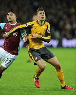Images Dated 3rd December 2016: Gabriel vs Payet: Intense Clash Between West Ham and Arsenal in Premier League