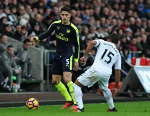 Swansea City V Arsenal - 2016-17 Prints: Gabriel vs Routledge: Intense Battle in Swansea City vs Arsenal Premier League Clash