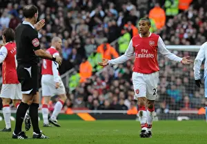 Gael Clichy (Arsenal) talks to referee Mark Clattenburg