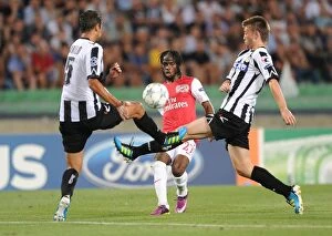 Images Dated 24th August 2011: Gervinho Faces Off Against Neuton and Danilo Larangeria in Udinese vs Arsenal UEFA Champions