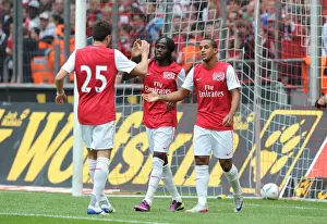 Gervinho, Jenkinson, and Walcott Celebrate Arsenal's Goals Against Cologne