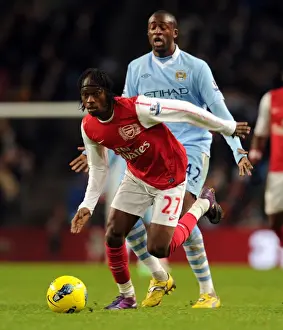 Manchester City V Arsenal 2011-12 Prints: Gervinho vs Yaya Toure: A Premier League Showdown at Etihad Stadium