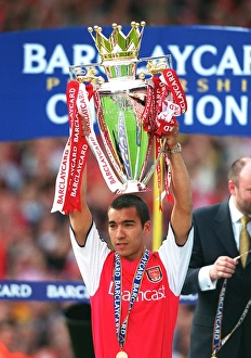 Giovanni van Bronckhorst lifts the F. A. Barclaycard Premiership Trophy