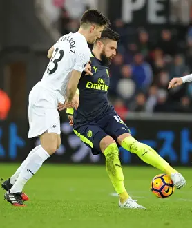 Swansea City V Arsenal - 2016-17 Prints: Giroud vs Fernandez: Intense Battle at Swansea's Liberty Stadium - Arsenal vs Swansea City