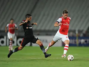 Besiktas V Arsenal 2014-15 Prints: Giroud vs Motta: Arsenal's Olivier Giroud Clashes with Besiktas Ramon Motta in UEFA Champions League Qualifier