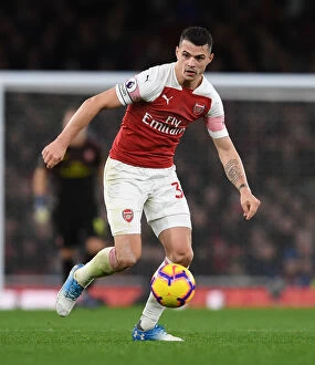 Images Dated 8th December 2018: Granit Xhaka: Arsenal's Midfield Mastermind in Action against Huddersfield Town