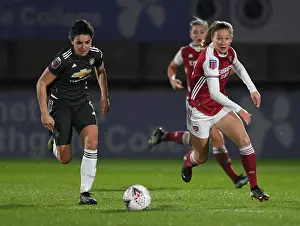 Great attempt! Here are a few alternative title suggestions for the image: 1. FA WSL Rivalry: Malin Gut vs Jess Sigsworth - Arsenal Women vs Manchester United Women in Empty Stands 2. Empty Meadow Park: Malin Gut and Jess Sigsworth Battle it Out in the FA WSL 3. The Silent Showdown: Arsenal Women vs Manchester United Women - Malin Gut vs Jess Sigsworth in an Empty Stadium 4. FA WSL Clash: Malin Gut and Jess Sigsworth Go Head to Head in an Empty Meadow Park 5. Arsenal Women vs Manchester United Women: Malin Gut and Jess Sigsworth Face Off in an Empty Stadium (FA WSL 2020-21)