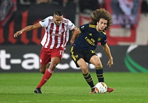 Images Dated 20th February 2020: Guendouzi vs. Christodoulopoulos: Olympiacos vs. Arsenal, UEFA Europa League 2019-20