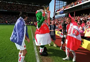 Gunner lifts the Premiership trophy watched by Thierry Henry and Robert Pires