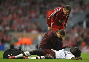 Injured Emmanuel Adebayor is treated by Arsenal physio Gary Lewin