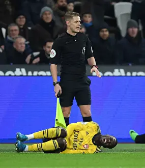 Injured Nicolas Pepe: A Moment of Agony in West Ham United vs Arsenal FC, Premier League