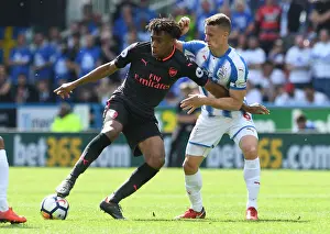 Huddersfield Town V Arsenal 2017-18 Prints: Intense Battle: Alex Iwobi vs. Jonathan Hogg in Premier League Showdown