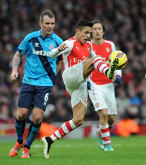 Arsenal V Stoke City 2014-15 Prints: Intense Battle: Alexis Sanchez vs. Glenn Whelan at Arsenal vs. Stoke City (2014-15)