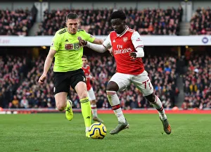 Intense Battle: Bukayo Saka vs. John Lundstram - Arsenal's Clash Against Sheffield United