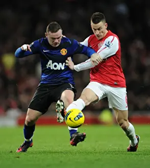 Intense Battle: Koscielny Tackles Rooney in Arsenal vs Manchester United
