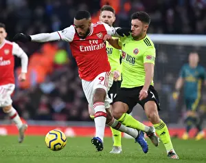 Intense Battle: Lacazette vs Baldock in Arsenal vs Sheffield United Premier League Clash