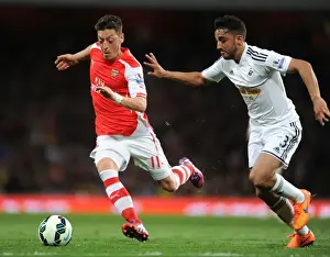 Intense Battle: Mesut Ozil vs. Neil Taylor at Arsenal's Emirates Stadium (Arsenal vs. Swansea City, Premier League 2014/15)