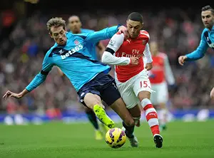 Arsenal V Stoke City 2014-15 Prints: Intense Battle: Oxlade-Chamberlain vs Crouch at the Emirates Stadium - Arsenal vs Stoke City