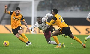 Wolverhampton Wanderers v Arsenal 2020-21 Collection: Intense Battle: Pepe vs Wolves Defense - Tenacious Tackles