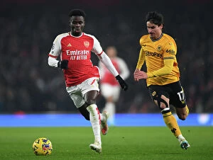 Arsenal v Wolverhampton Wanderers 2023-24 Collection: Intense Battle: Saka vs. Bueno - Pressure Cooker Moment in the 2023-24 Arsenal vs
